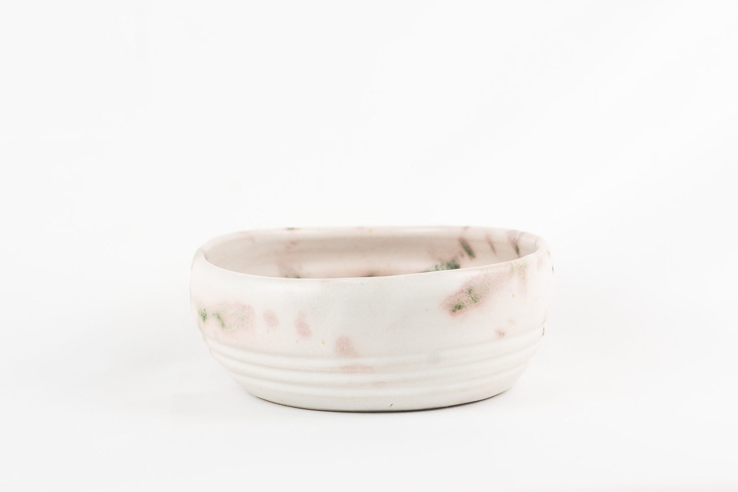 White glaze bowl with splashed oxide with added texture