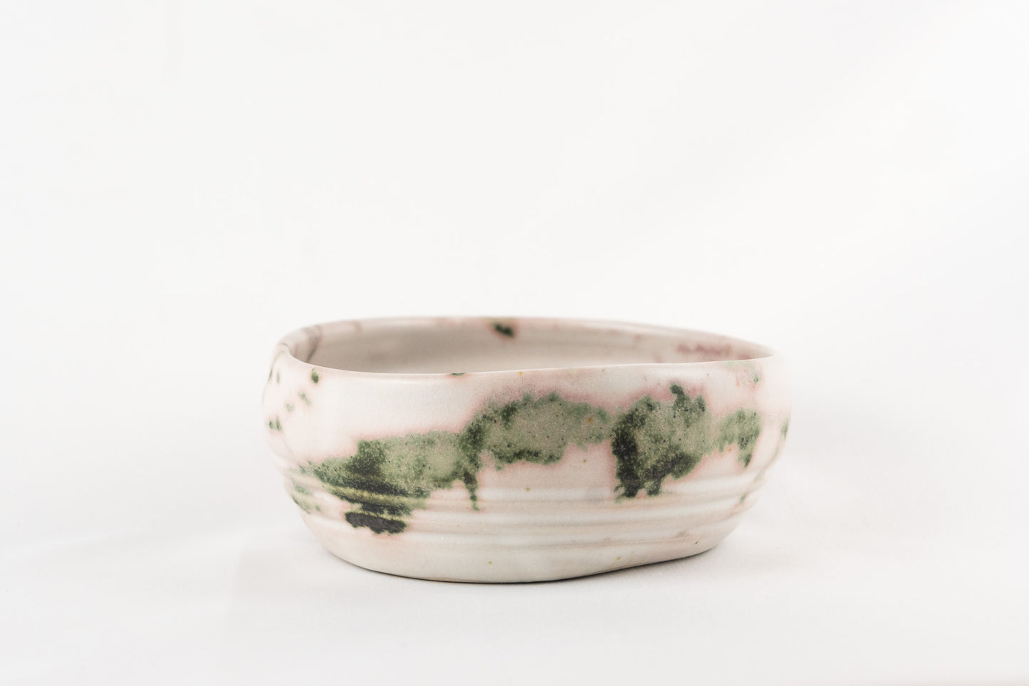 White glaze bowl with splashed oxide with added texture