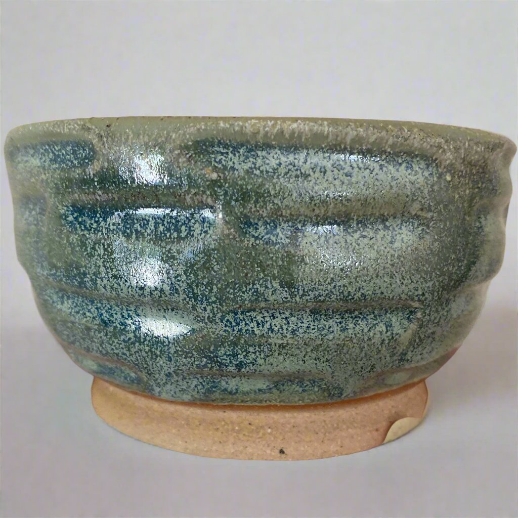 Pistachio glazed bowl with hand cut features