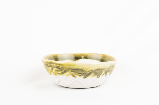 Olive green, matt white glazed bowl with carved features