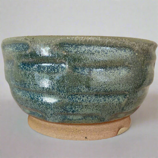 Pistachio glazed bowl with hand cut features
